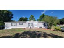 Charming single-story home with a well-maintained lawn and welcoming front porch area, great curb appeal at 6222 Dovecrest Trl, Lakeland, FL 33810