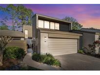 Charming condo with a two-car garage, lush landscaping, and modern architectural details at 85 Carolwood Blvd, Fern Park, FL 32730