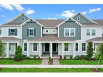 Charming two-story townhome with a covered porch and manicured landscaping at 13536 Autumn Harvest Ave, Winter Garden, FL 34787