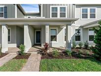 Charming front porch with brick pathway and landscaped garden at 13536 Autumn Harvest Ave, Winter Garden, FL 34787