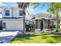 Charming two-story home featuring a landscaped yard and stone accents at 13722 Fox Glove St, Winter Garden, FL 34787