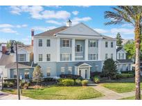 Beautiful building featuring distinct architectural style, well-maintained landscaping, and a welcoming entrance at 1598 Heritage Crossing Ct # 302, Reunion, FL 34747
