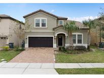 Charming two-story home featuring a well-maintained lawn and a two-car garage on a sunny day at 1639 Lima W Ave, Kissimmee, FL 34747