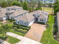 Beautiful single-story home with paver driveway and lush landscaping, located near a golf course at 231 Cherokee Hill Ct, Deland, FL 32724