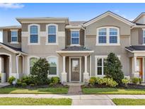 Inviting townhome with a well-maintained front yard and charming architectural details at 2694 Giardino Loop, Kissimmee, FL 34741