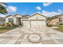 Beautiful single-Gathering home featuring a paver driveway and two-car garage in a well-maintained neighborhood at 9210 Sw 60Th Court Rd, Ocala, FL 34476