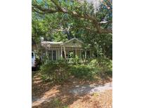 Charming cottage-style home with mature trees offering privacy and shade in a tranquil setting at 15 W Vanderbilt St, Orlando, FL 32804