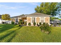 Charming single-story home featuring a well-manicured lawn and landscaping, showcasing its inviting curb appeal at 1878 Durban Way, Apopka, FL 32712