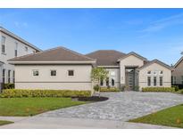 Beautiful single-story home featuring manicured landscaping and a stone driveway for added curb appeal at 2217 Lake Sylvan Oaks Ct, Sanford, FL 32771