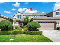 Two-story house with two car garage, well-manicured lawn, and lush landscaping at 585 Cruz Bay Cir, Winter Springs, FL 32708