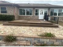 Back deck with stairs leading down to a brick patio, offering an outdoor living space at 947 N Atmore Cir, Deltona, FL 32725