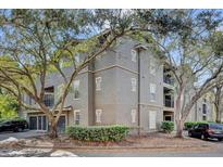Three-story condo building with balconies and mature trees around the property at 1321 Arbor Vista Loop # 101, Lake Mary, FL 32746
