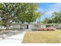 Charming single-story home featuring well-maintained landscaping, a covered carport, and a welcoming facade at 2417 Healy Dr, Orlando, FL 32818