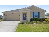 Charming single-story home with a well-manicured lawn and a welcoming front porch at 4718 Magnetite Loop, Mount Dora, FL 32757