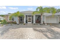 Charming single-story home featuring well-manicured landscaping and an inviting screened porch entrance at 720 Basin Dr, Kissimmee, FL 34744