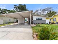 Charming single-Gathering home with a covered carport, lush landscaping, and a well-maintained front yard at 1500 Pinecrest Pl, Orlando, FL 32803
