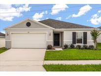 Charming single-story home featuring a two-car garage, well-maintained lawn, and classic curb appeal at 640 Royal Palm Dr, Dundee, FL 33838