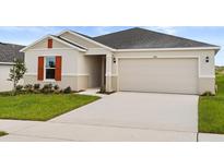 Charming single Gathering home boasts a two-car garage, well-maintained lawn, and neutral stucco at 644 Royal Palm Dr, Dundee, FL 33838
