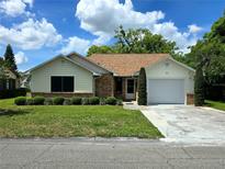 Charming single-story home features a well-manicured lawn, lush landscaping, and a convenient one-car garage at 1016 Monroe Ave, St Cloud, FL 34769
