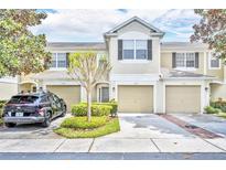 Charming townhome with a well-manicured lawn and attached garages in a desirable neighborhood at 1541 Florentino Ln, Winter Park, FL 32792