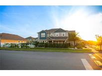 Lovely two-story home featuring lush landscaping, a privacy hedge, and inviting curb appeal at 2260 Rapollo Dr, Kissimmee, FL 34741