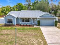 Charming single-story home with a well-manicured lawn and a one-car garage at 2617 Greywall Ave, Ocoee, FL 34761