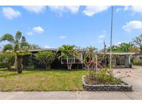 Charming single-story home with well-maintained landscaping and mature palm trees in a sunny neighborhood at 412 Stimson St, Orlando, FL 32839
