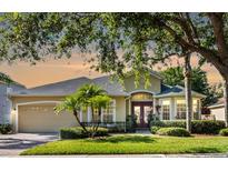 Charming single-story home with manicured lawn, mature landscaping, and an attached two-car garage at 4918 Oakway Dr, St Cloud, FL 34771