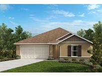 Charming one-story home featuring a neutral color scheme, a two-car garage, and tidy landscaping at 576 Mahogany Way, Dundee, FL 33838