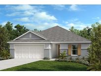 Charming single-story home showcasing a well-manicured lawn, neutral paint, and a two car garage at 652 Royal Palm Dr, Dundee, FL 33838