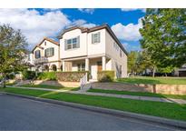 Attractive two-story home with a well-kept lawn and manicured shrubs in a lovely neighborhood at 9330 Meadow Hunt Way, Winter Garden, FL 34787