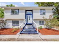 Two-story home featuring blue trim, complementing the white exterior and enhancing its curb appeal at 2550 Barren Oak Ct, Deland, FL 32720