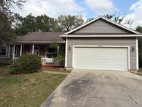 Charming single-story home with a two-car garage and well-maintained front yard at 13018 S Sunset Ter, Winter Garden, FL 34787
