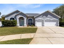 Charming single-story home featuring a well-manicured lawn and an attached two-car garage at 3469 Foxton Ct, Oviedo, FL 32765