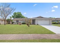 Charming single-story home with a well-manicured lawn and a two-car garage, perfect for suburban living at 4729 Arrow Rd, Orlando, FL 32812