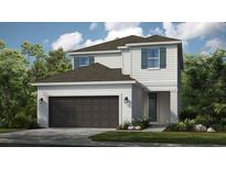 Charming two-story home with a two-car garage, neutral paint, and an inviting front entrance at 5646 Ficus Aurea St, Kissimmee, FL 34758