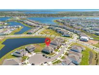 Stunning aerial view of a lakeside community highlighting the property's prime location near the water at 13231 Panama Beach Ct, Orlando, FL 32827