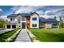 Modern two-story home featuring a manicured lawn, brick accents, and black trim windows at 1910 Glencoe Rd, Winter Park, FL 32789