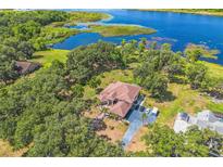 Sprawling estate home with lush landscaping and direct lake access at 2910 Frontier Dr, Kissimmee, FL 34744