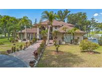 Stunning two-story home featuring meticulous landscaping and a circular driveway at 2910 Frontier Dr, Kissimmee, FL 34744