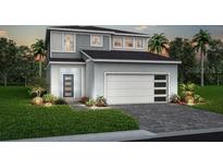 Two-story home with gray siding, two-car garage, paver driveway and a manicured lawn at 16147 Coastal Cove Ln, Clermont, FL 34714