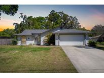 Charming single-story home with well-maintained lawn and attached two-car garage at 515 Columbus Ave, Orange City, FL 32763