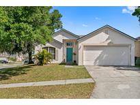Charming single-story home with a well-manicured lawn and a bright blue front door at 6749 Westlake Blvd, Orlando, FL 32810