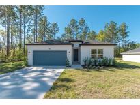 Charming single-story home featuring a well-manicured lawn and a convenient attached two-car garage at 7110 Sw 134Th St, Ocala, FL 34473