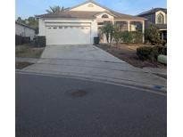 Charming single-story home featuring a two-car garage, covered porch, and well-maintained landscaping at 756 Obo Dr, Davenport, FL 33896