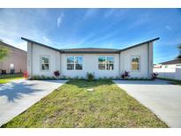 Beautiful single-Gathering home featuring a modern design, manicured lawn, and freshly poured driveway at 804 Colville Dr, Kissimmee, FL 34759