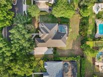 A bird's eye view of a single Gathering home with a private pool in a lush neighborhood at 859 Windcrest Pl, Winter Springs, FL 32708