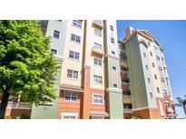 Colorful building exterior featuring balconies and a well-maintained facade at 8743 S The Esplanade # 18, Orlando, FL 32836