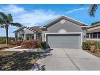 Traditional single-Gathering home featuring a two-car garage and well-maintained landscaping at 1028 Marietta Ln, Eustis, FL 32726