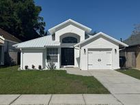 Charming single-story home with a well-manicured lawn and a freshly painted, modern exterior at 1538 Brookebridge Dr, Orlando, FL 32825